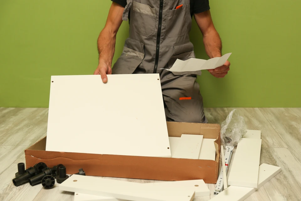 Chantier extérieur de construction avec artisan utilisant une perceuse-visseuse électrique jaune sur une poutre en bois